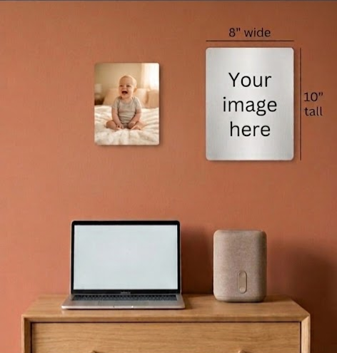 Wall with a framed photo of a baby and a customizable photo frame on an orange wall.